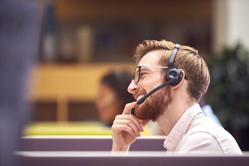 businessman in cubicle wearing headset talking to 2021 12 09 06 51 04 utc scaled 1